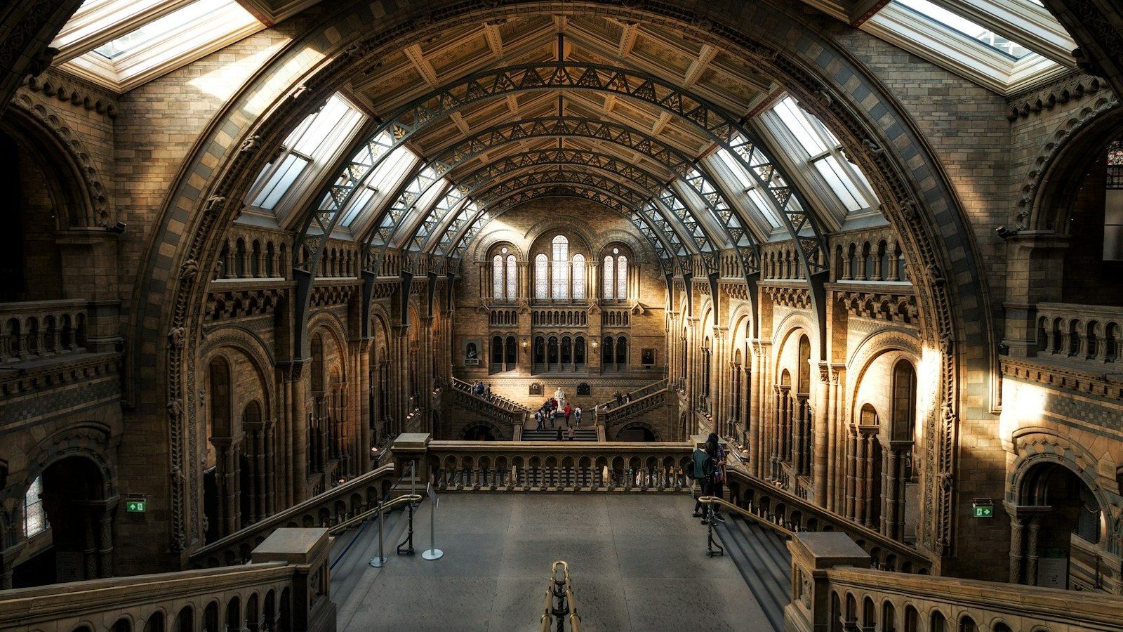 The grand vaulted hall of the Natural History Museum in London with stone arches